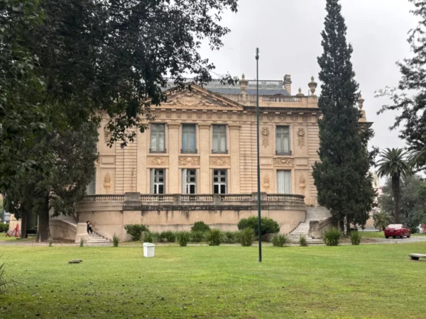 Elegant architecture and lush greenery surround a historic building in Córdoba, Argentina, showcasing the city's rich heritage.