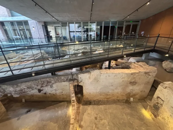 Historic ruins below a modern glass bridge, showcasing the blend of ancient and contemporary architecture in Córdoba, Argentina.