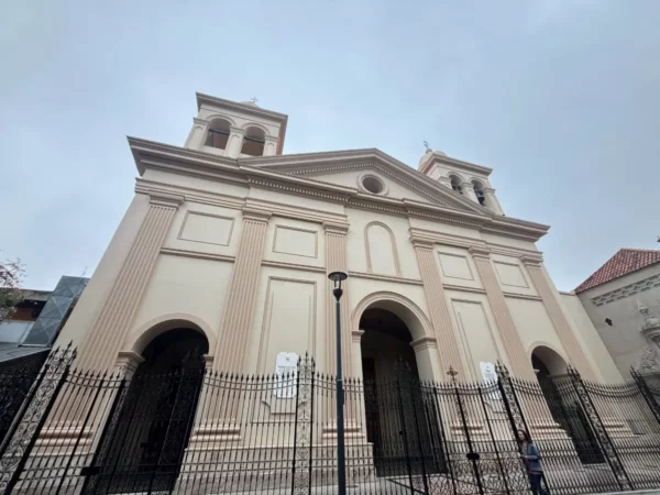 Historic architecture featuring detailed facade and twin bell towers in Córdoba, Argentina, under a cloudy sky.