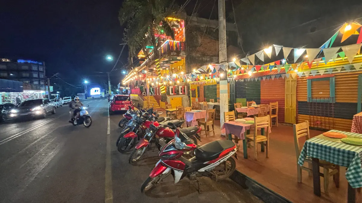parked motorbikes in front of brightly lit restaurant in puerto iguazu, argentina