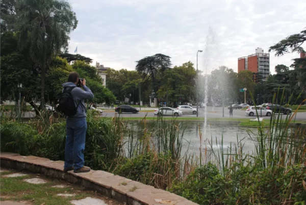 Capturing the fountain at Parque Urquiza, surrounded by greenery and cityscape in Rosario, Santa Fe, Argentina.