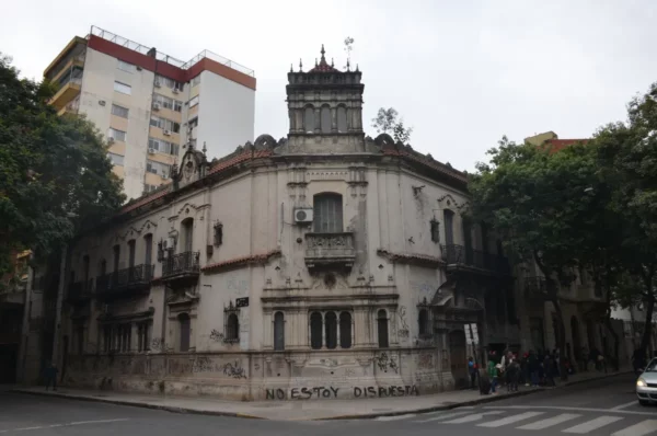 Historic architecture contrasts with modern buildings in Rosario, Santa Fe, Argentina, showcasing a mix of styles and urban life.