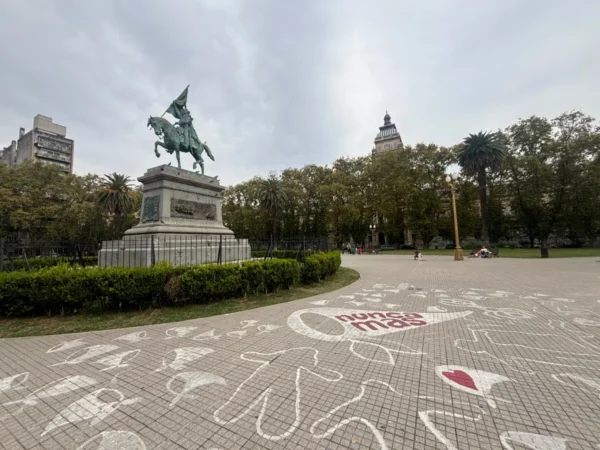 Horse-mounted statue in a park with patterned ground, surrounded by greenery in Rosario, Santa Fe, Argentina.