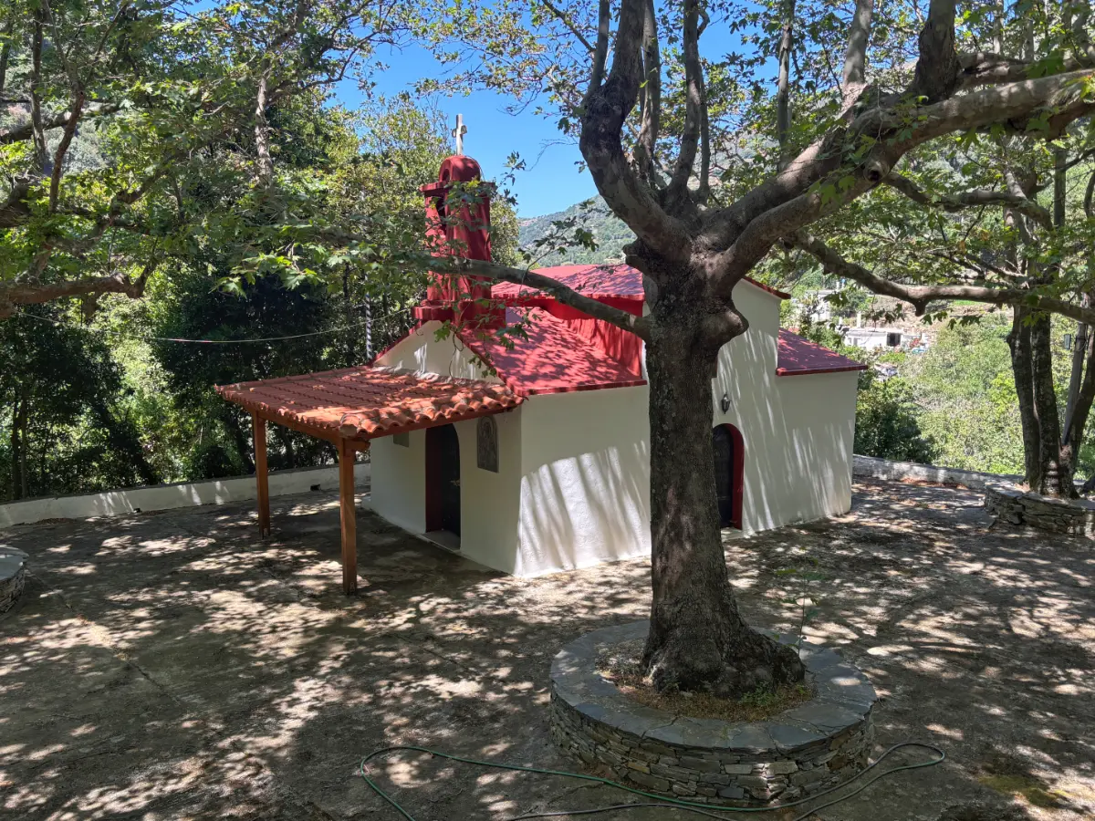 small greek church with red roof in village of lenosaioi on evia island