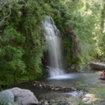 two women Sitting below platanistos waterfall in south evia