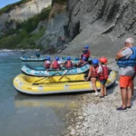 Rafting boats and guides preparing on the rocky shore of the Arachtos River in Tzoumerka, Epirus, Greece