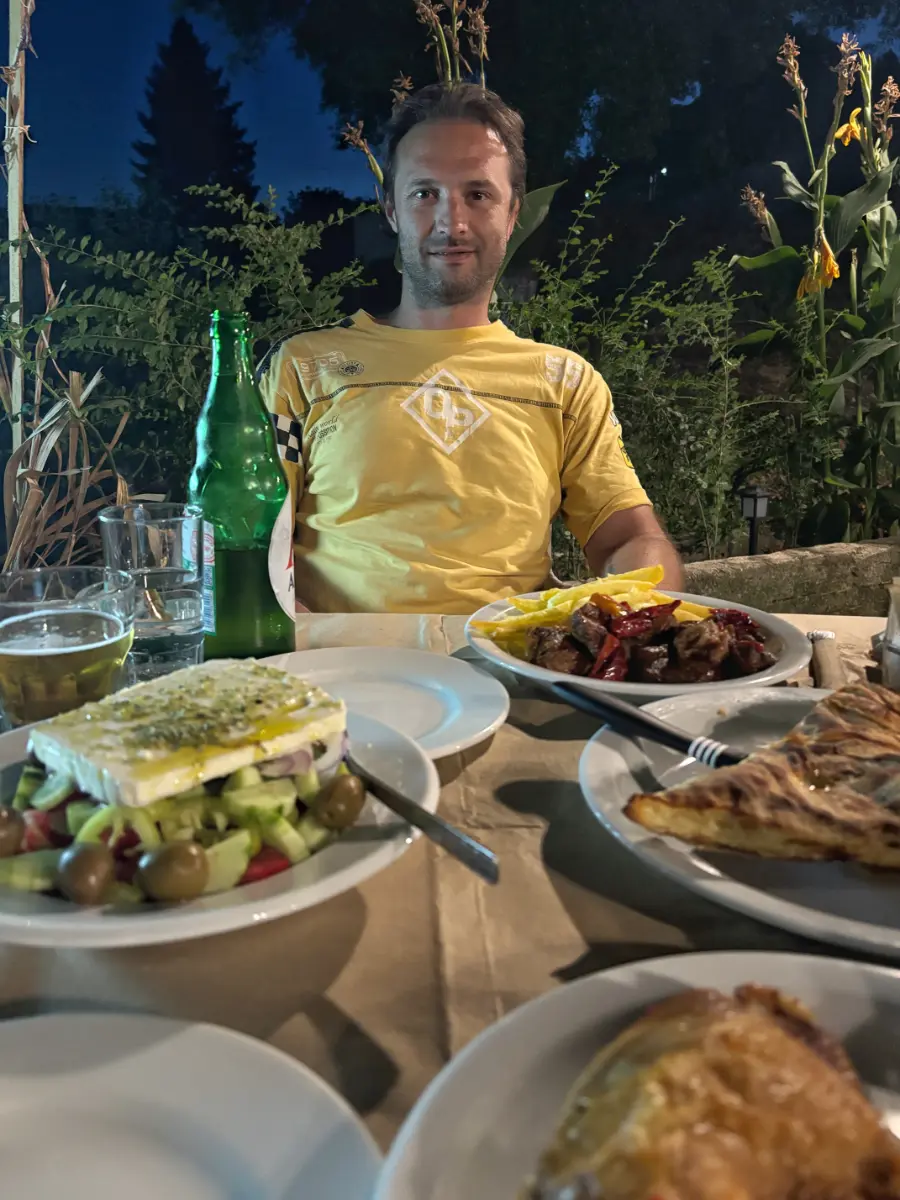 Greek taverna dinner in Elliniko, Tzoumerka — Greek salad, grilled meat, pies, and local dishes on the table