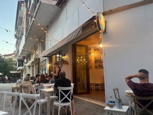 Charming outdoor dining scene in Florina, Greece, with twinkling lights and stylish outdoor seating.