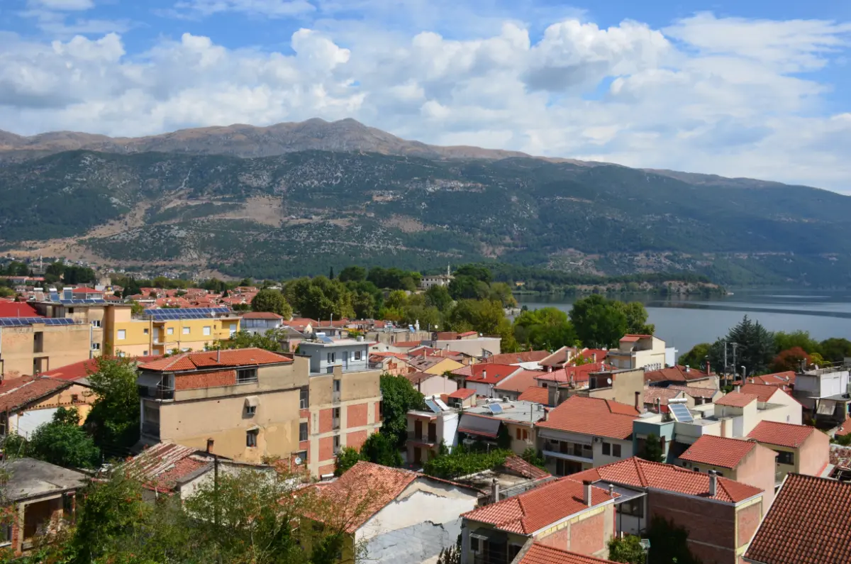 panoramic view of Ioannina with red-tiled rooftops, Lake Pamvotida, and the Pindus mountains in the background, Greece