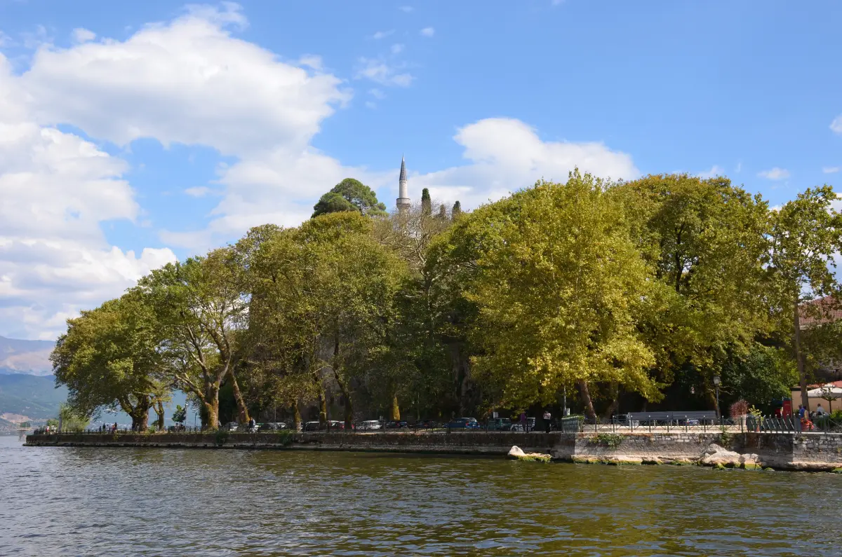 Aslan Pasha Mosque minaret rising above the plane trees in Ioannina, Greece