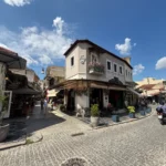 cobbled street with cafés and traditional buildings in the old town of Ioannina, Greece