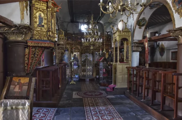 Ornate architecture and intricate decorations inside a historic church on Ioannina Island, Greece, showcasing vibrant colors and details.