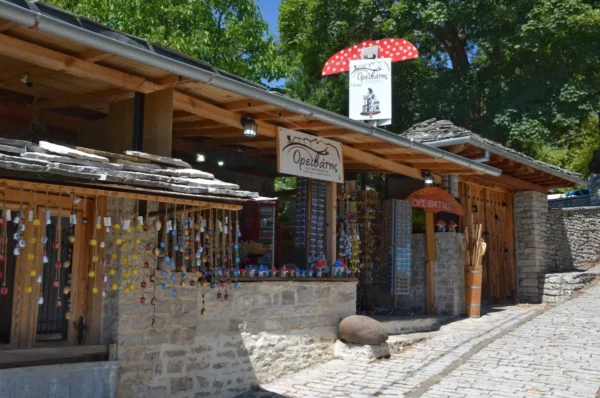 Charming stone shop with wooden accents and vibrant decorations in Monodendri, Zagorochoria, Ioannina, Greece.