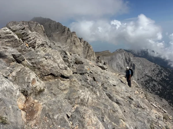 Breathtaking view from Mount Olympus in Pieria, Greece, showcasing rocky terrain and dramatic cloud formations.