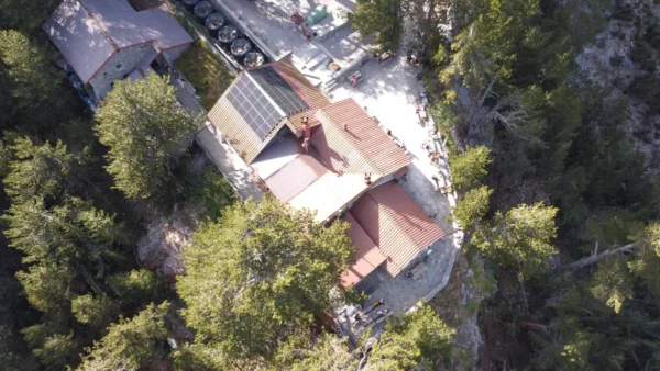 bird's eye view of Spilios Agapitos refuge on Mount Olympus, perched above the treeline on rocky alpine slopes along the E4 trail.