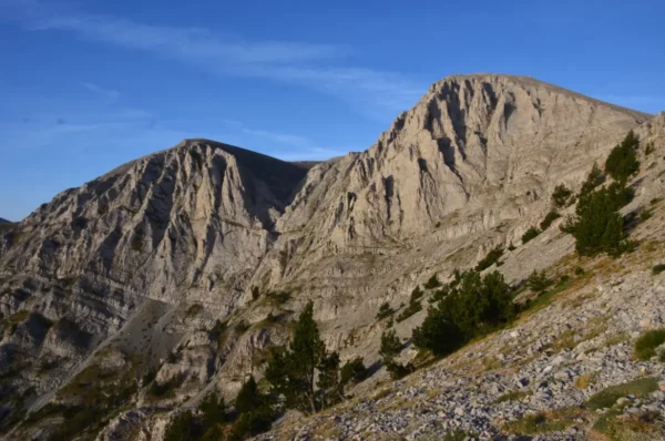 Breathtaking rugged peaks of Mount Olympus in Pieria, Greece, showcasing rocky formations against a clear blue sky.