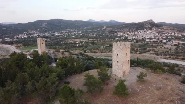Twin medieval towers of Mytikas overlooking the Lelantine Plain, with the Castle of Fylla visible in the background, central Evia, Greece