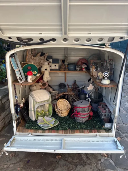 Charming display of vintage items and crafts in an open trailer, showcasing local artistry in Papigo, Zagorochoria, Greece.