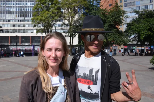 Street performer dressed as Michael Jackson posing with visitors in Rosario Square, Bogotá