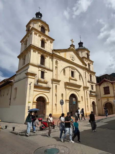 Historic façade of the Church of Our Lady of La Candelaria in Bogotá, viewed from a street corner in the historic center