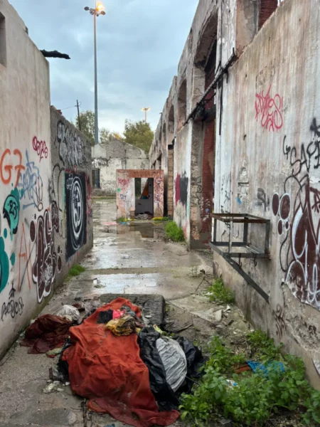 Chalkis, Euboea features a weathered alleyway with graffiti-covered walls and scattered debris, reflecting urban decay.