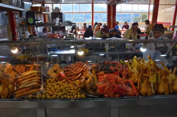 Buffet counter with roasted meats, sausages, potatoes, and other traditional Colombian dishes at a restaurant on Monserrate, Bogotá