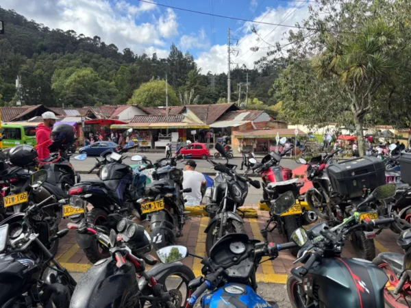Parking lot filled with motorcycles at the Monserrate trailhead in Bogotá on a busy Sunday morning