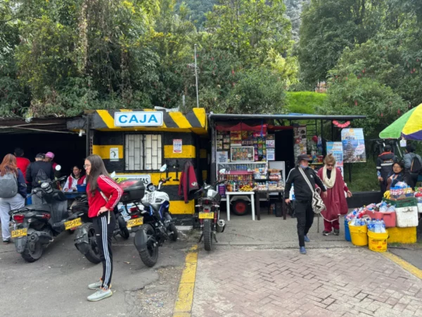 Parking area and market stalls beside the Monserrate trailhead in Bogotá