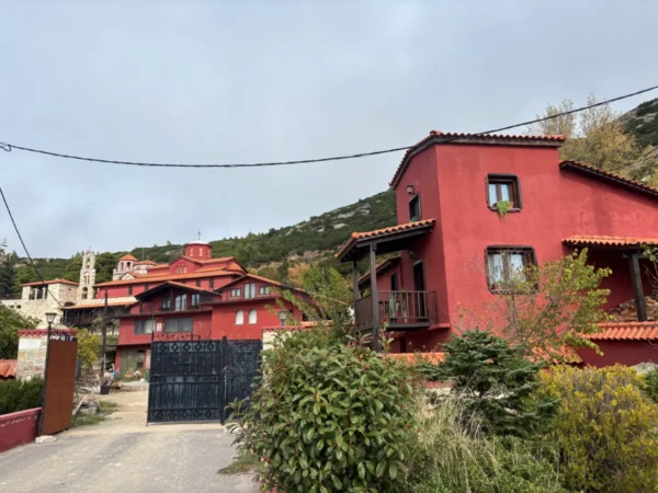 Red-roofed buildings surround the entrance to Saint Panteleimon Monastery on Mount Pentelicus in Attica, Greece.