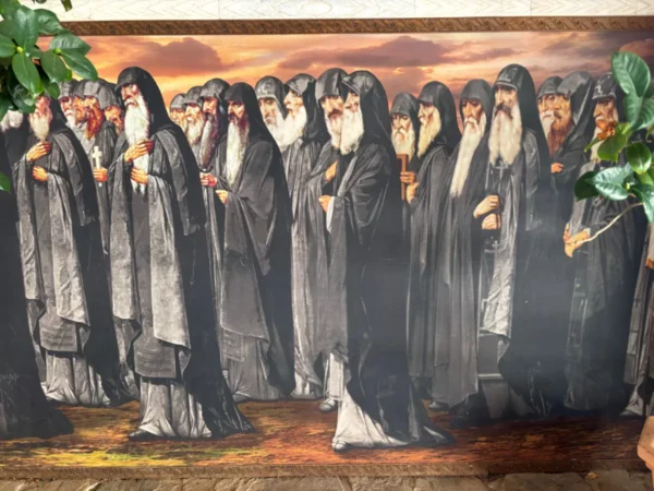 Monks in black robes stand in a serene formation, embodying tranquility at the Saint Panteleimon Monastery, Mount Pentelicus, Attica, Greece.