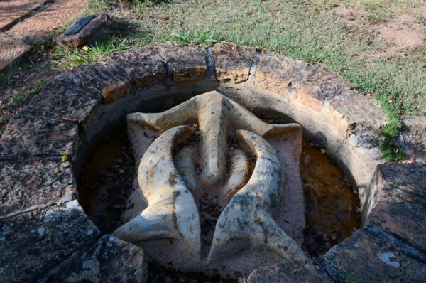 Stone sculpture set in a circular planter at Barichara's Jorge Delgado Sierra Arts Park