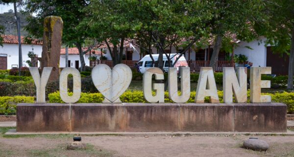 “Yo ♥ Guane” sign in Guane’s main square, with trees and white colonial buildings behind it