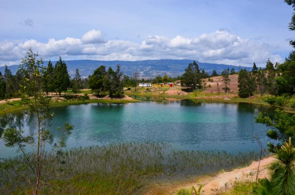 Panoramic view of a turquoise lake at Pozos Azules with mountains in the background, Villa de Leyva, Boyacá, Colombia