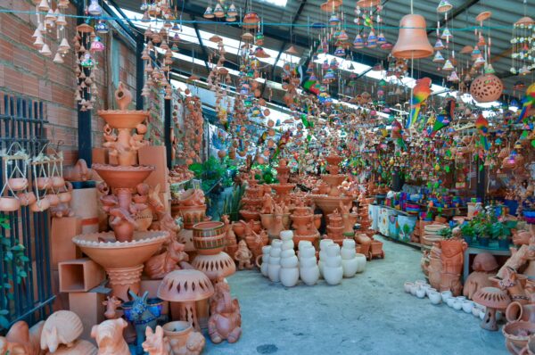 Colorful pottery and handcrafted decorations displayed inside a ceramics shop in Ráquira, Boyacá, Colombia