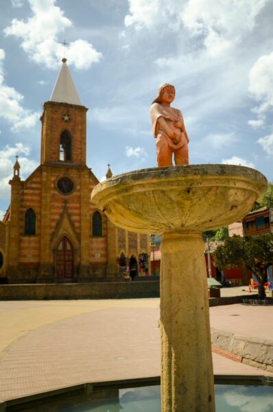 Stone fountain with a ceramic statue of a urinating nude child in the main square of Ráquira, Boyacá, Colombia