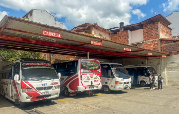 Buses parked at a terminal in San Gil, with route signs for Barichara and other nearby destinations