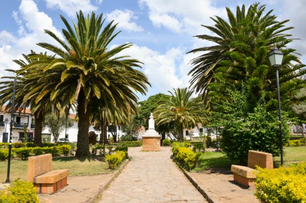 Pathway lined with palm trees leading to the Antonio Nariño monument in Antonio Nariño Park, Villa de Leyva, Boyacá, Colombia
