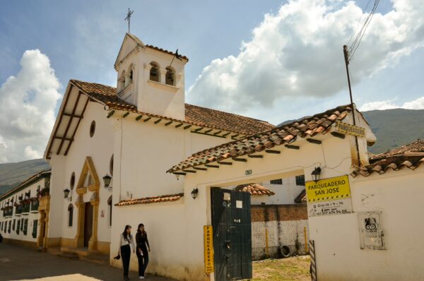 Façade of Capilla San José with its bell tower and adjoining colonial buildings in Villa de Leyva, Boyacá, Colombia