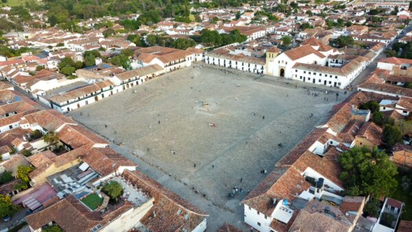 Aerial view of Plaza Mayor in Villa de Leyva, Boyacá, Colombia, surrounded by colonial buildings and terracotta roofs