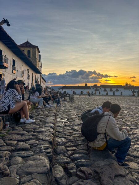 People watching the sunset from Plaza Mayor in Villa de Leyva, Boyacá, Colombia