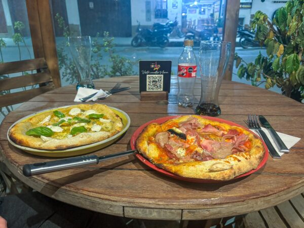 Freshly baked pizza on a wooden board at Europan bakery and pizzeria in Villa de Leyva, Boyacá, Colombia