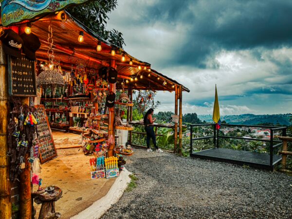 Colorful souvenirs and local crafts are displayed at a bustling shop in Alto de la Cruz, Salento, Quindío, Colombia.