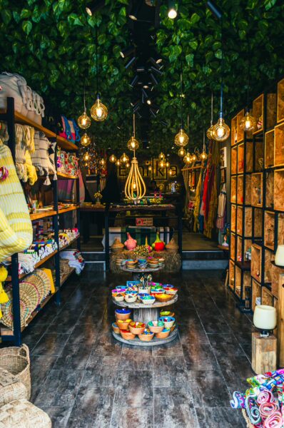Brightly lit shop on Calle Real in Salento, Quindio, Colombia, with colorful textiles and handcrafted items for sale.