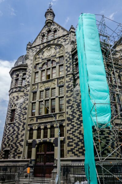 Palacio de la Cultura Rafael Uribe in Medellín, showcasing its distinctive patterned façade and scaffolding for restoration.