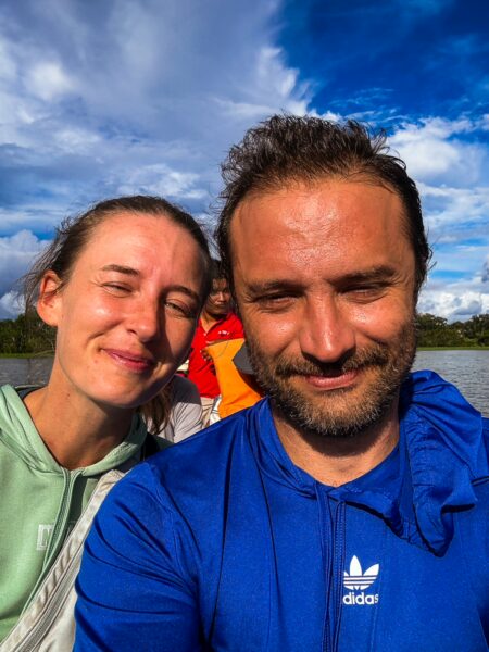 Happy travelers enjoying a boat ride on Pirana Lake in Gamboa Nature Reserve, surrounded by vibrant blue skies.