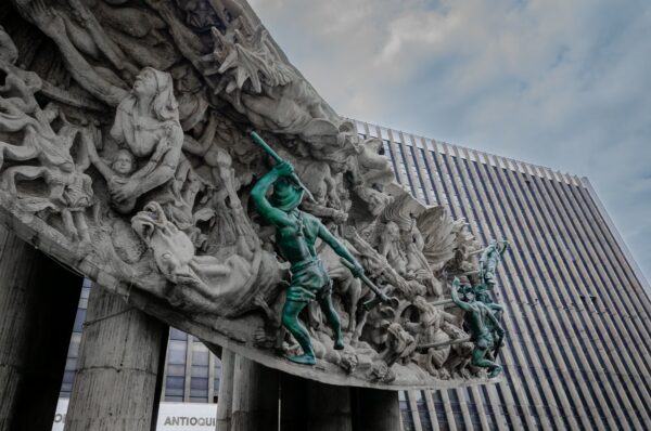 Monumento a la Raza in Medellín features intricate sculptures depicting historical themes against a backdrop of modern architecture.