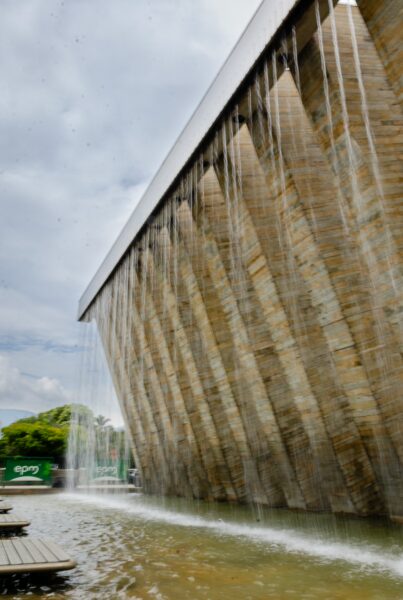 Puerta Urbana water feature with tall tilted pillars and cascading water in Medellín