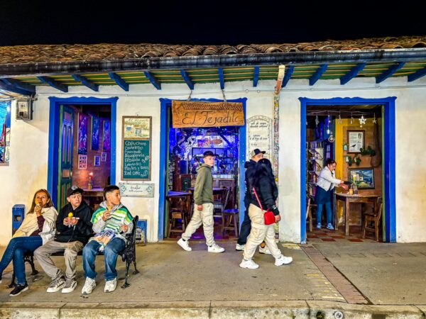 Calle Real in Salento Quindío features vibrant shops, lively locals, and colorful colonial architecture at night.