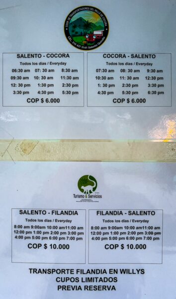 Schedules and pricing for transportation between Salento and Cocora, displayed on a notice board in Salento, Quindío, Colombia.