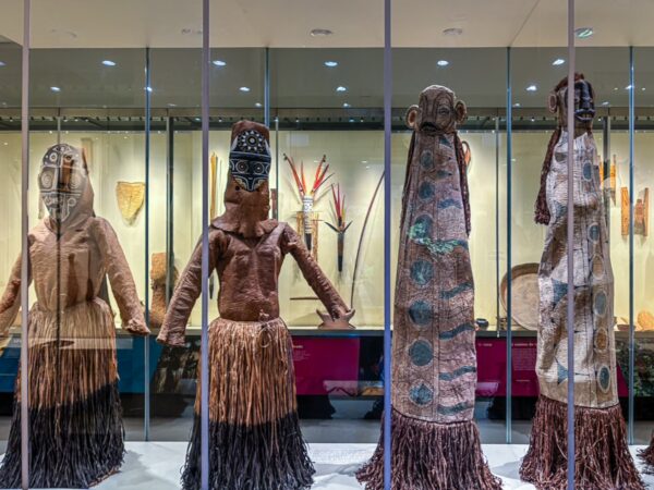 Ethnographic artifacts on display at the Ethnographic Museum in Leticia, Amazonas, Colombia, showcasing traditional attire and craftsmanship.